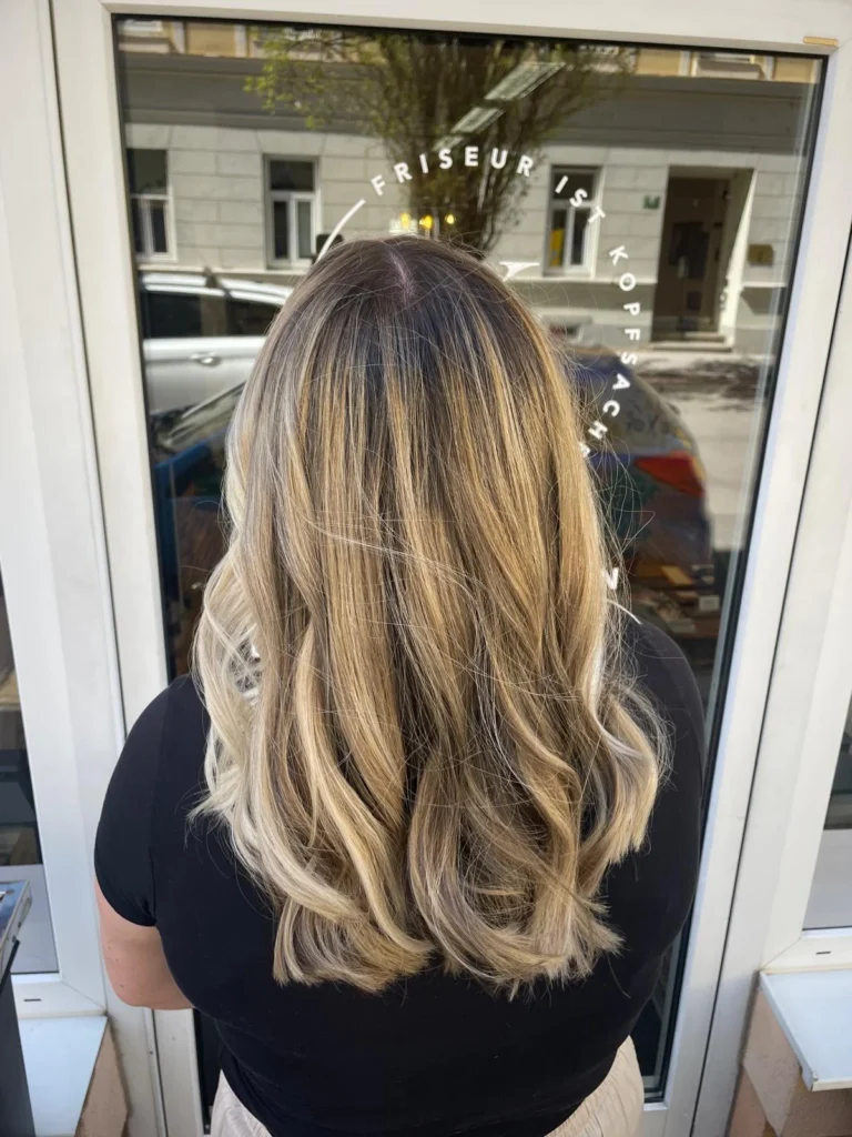 Blonde Balayage mit langen Wellen bei Friseur ist Kopfsache