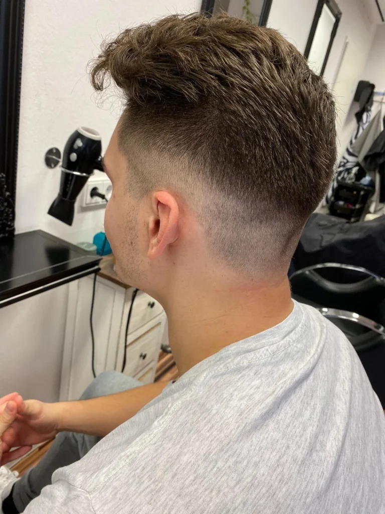 Dunkler Herrenhaarschnitt mit Fade und strukturiertem Deckhaar